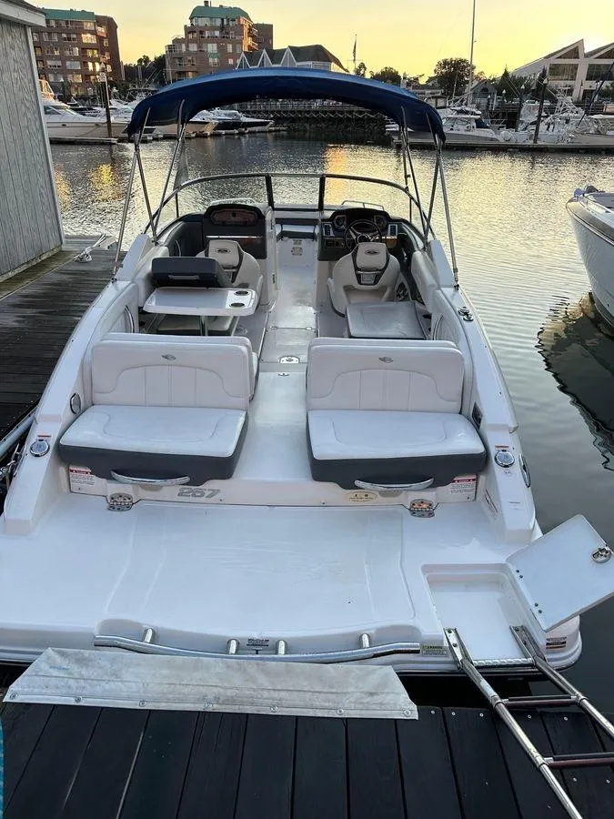 Slide: The Image of 2014 Chaparral 257 SSX boat docked at marina, featuring spacious seating and canopy. - 5