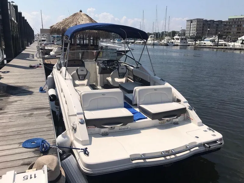 Slide: The Image of 2014 Chaparral 257 SSX boat docked at marina with blue canopy. - 7