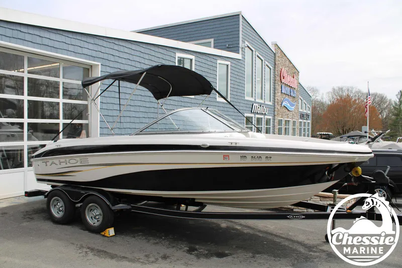 Slide: The Image of 2007 Tahoe Q6 boat with canopy on trailer outside dealership. - 1
