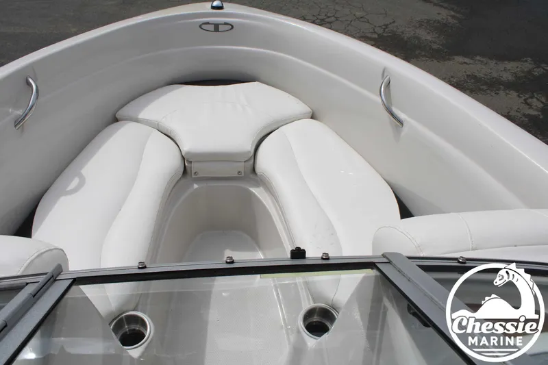 Slide: The Image of 2007 Tahoe Q6 boat interior with white seating and cup holders, Chessie Marine logo visible. - 14