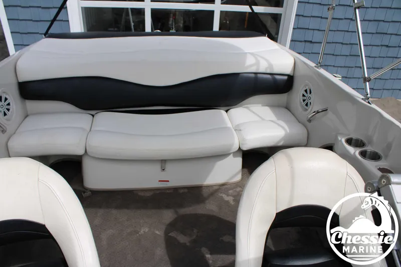 Slide: The Image of 2007 Tahoe Q6 boat interior with white and black seating, cup holders, and speakers. - 15