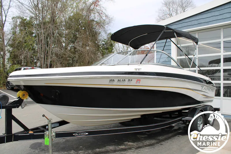 Slide: The Image of 2007 Tahoe Q6 boat on trailer with canopy, parked outdoors near a building. - 9