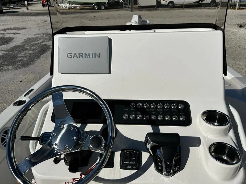 Slide: The Image of 2025 Skeeter SX221 boat console with Garmin navigation, steering wheel, and control panel. - 11