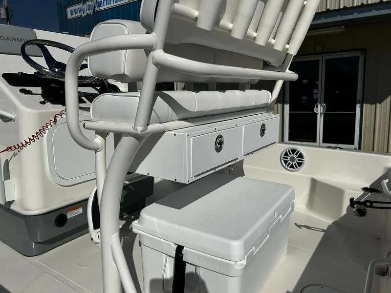 Slide: The Image of 2025 Skeeter SX221 boat interior with seating, storage, and control panel. - 13