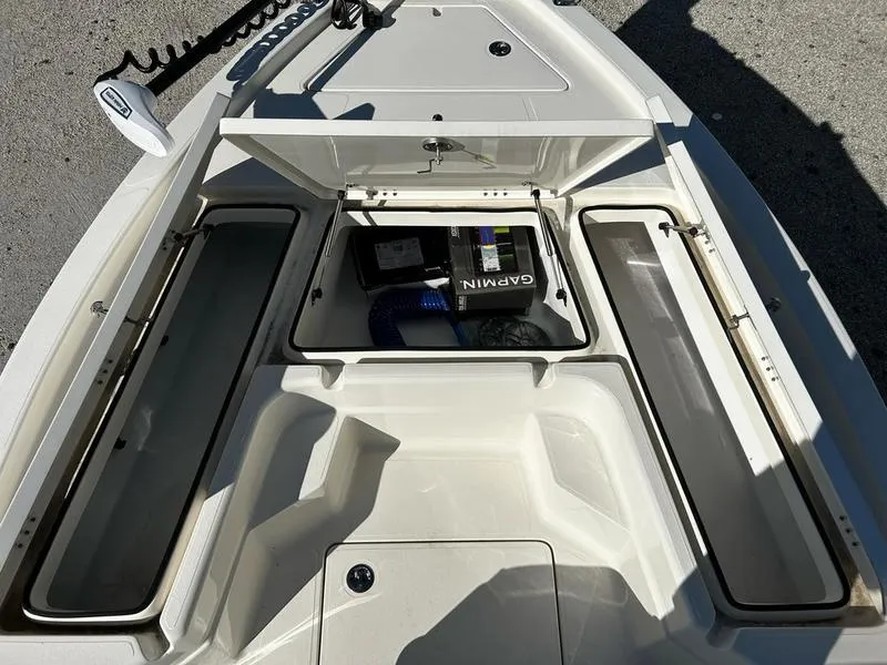 Slide: The Image of 2025 Skeeter SX221 boat storage compartments with Garmin equipment, open and ready for use. - 8