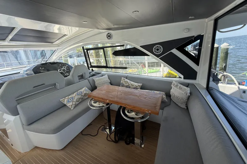 Slide: The Image of Luxurious interior of 2023 Beneteau Gran Turismo 45 yacht with elegant seating and wooden table. - 10