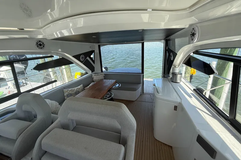 Slide: The Image of Interior of 2023 Beneteau Gran Turismo 45 yacht with modern seating and waterfront view. - 12