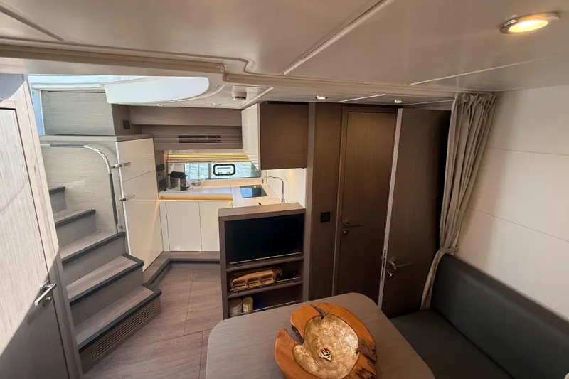 Slide: The Image of 2023 Beneteau Gran Turismo 45 interior with modern kitchen and cozy seating area. - 16