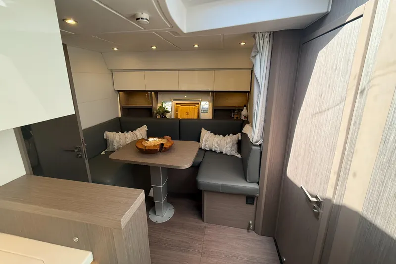 Slide: The Image of Interior of 2023 Beneteau Gran Turismo 45 yacht, featuring a cozy dining area. - 17