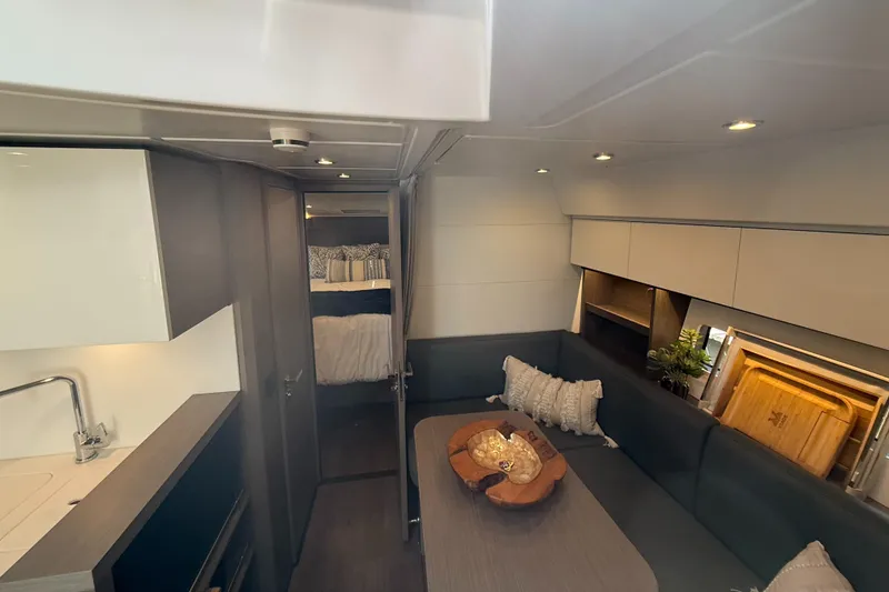 Slide: The Image of 2023 Beneteau Gran Turismo 45 interior with modern kitchen and cozy seating area. - 18