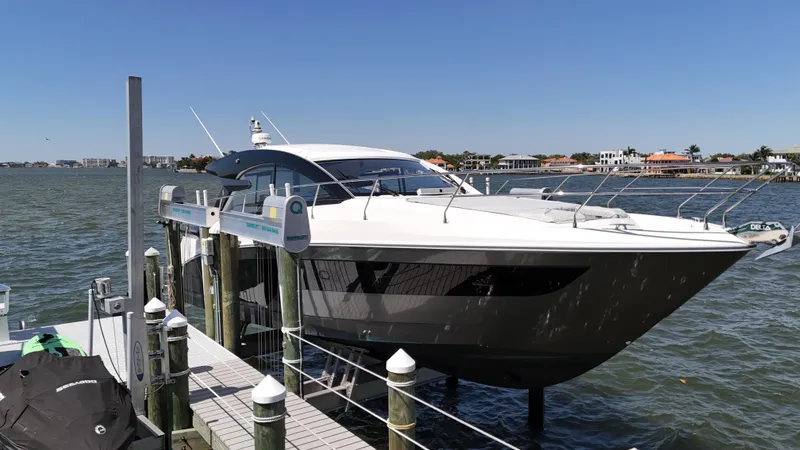 Slide: The Image of 2023 Beneteau Gran Turismo 45 yacht docked by waterfront homes. - 25