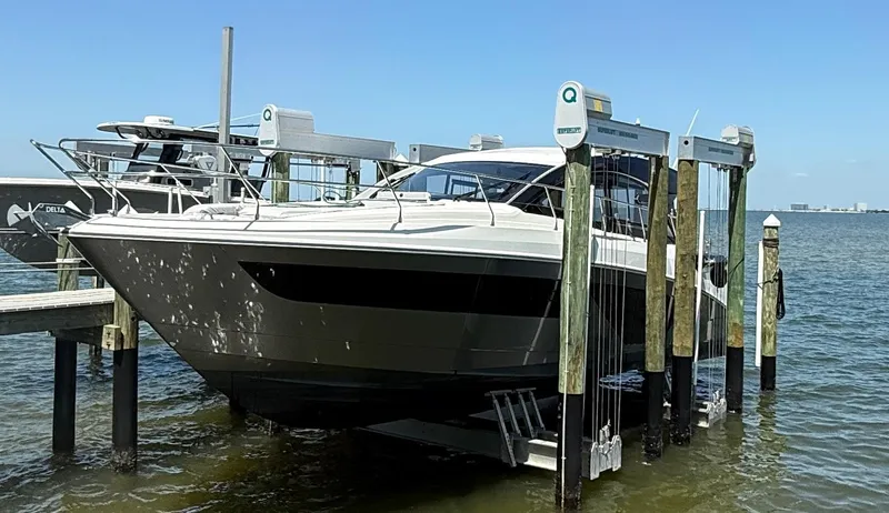 Slide: The Image of 2023 Beneteau Gran Turismo 45 yacht docked on a lift in a marina. - 5