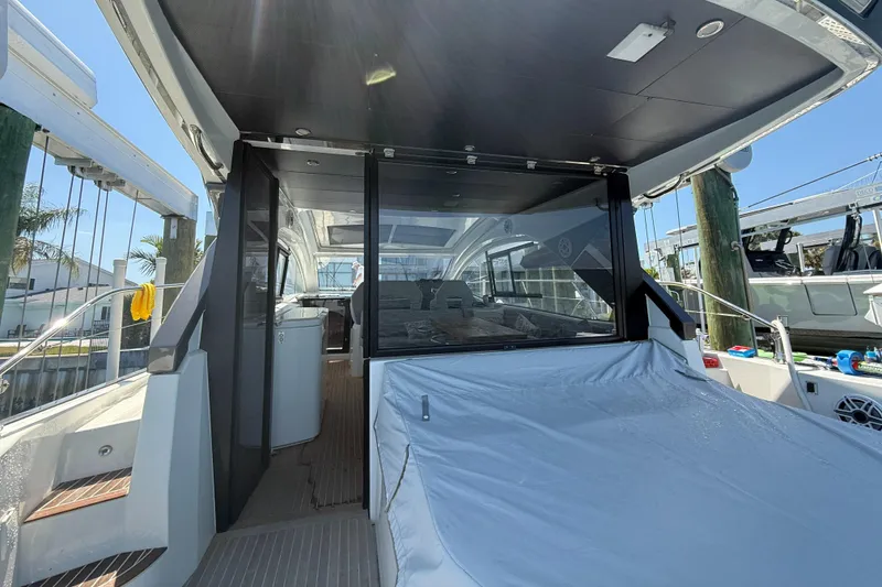 Slide: The Image of 2023 Beneteau Gran Turismo 45 yacht interior with covered seating area and modern design. - 7