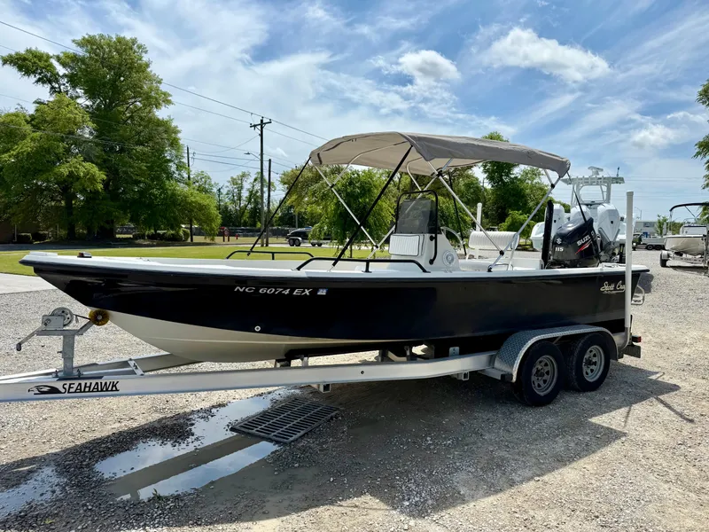 Slide: The Image of 2015 Stott Craft SCV 2160 Bay boat on trailer under sunny sky. - 10