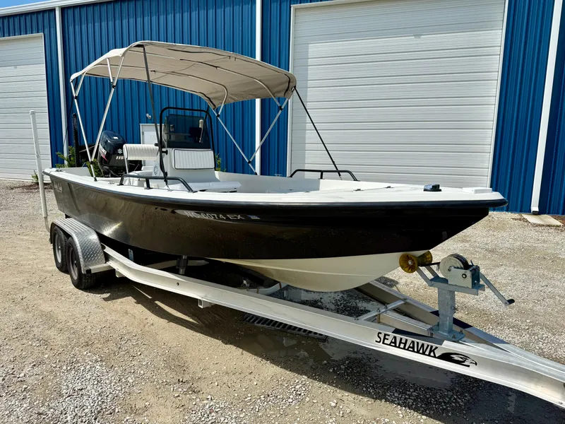 Slide: The Image of 2015 Stott Craft SCV 2160 Bay boat on trailer, parked outside blue storage units. - 15