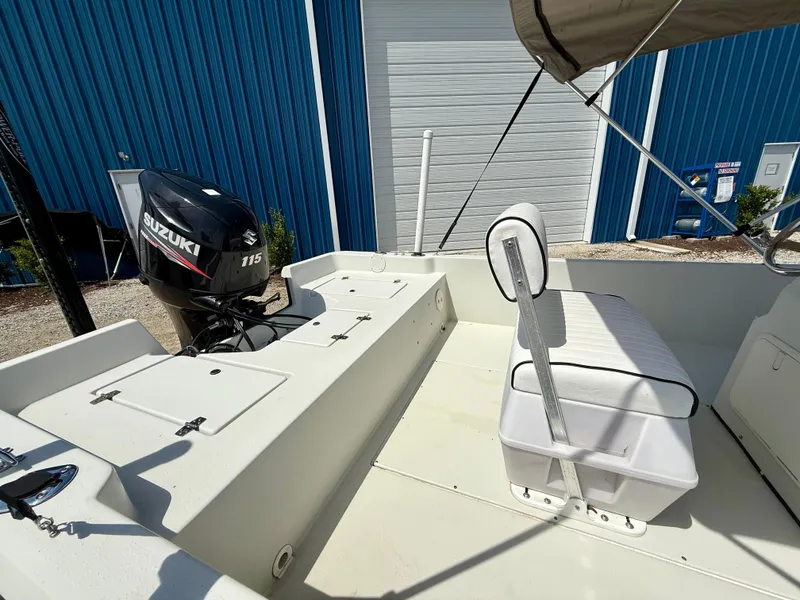 Slide: The Image of 2015 Stott Craft SCV 2160 Bay boat with Suzuki 115 engine, docked near blue building. - 17