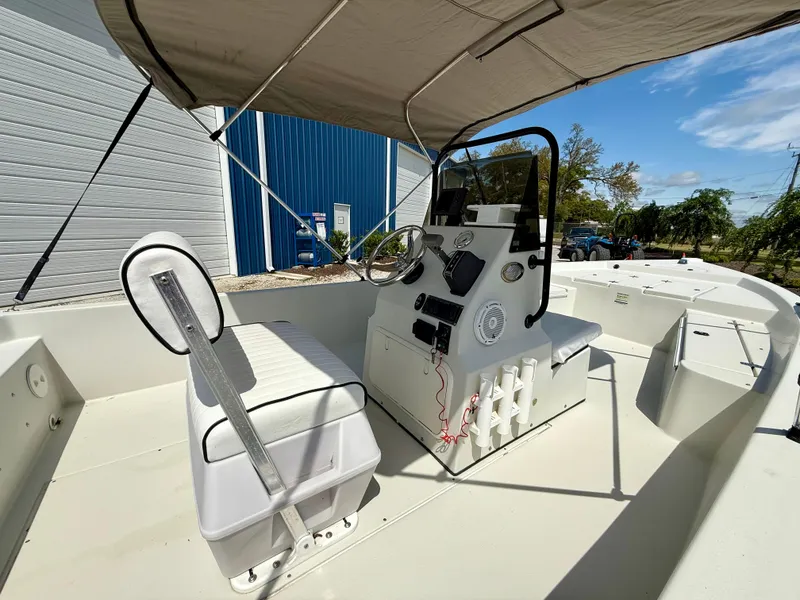 Slide: The Image of 2015 Stott Craft SCV 2160 Bay boat interior with console and seating under canopy. - 18