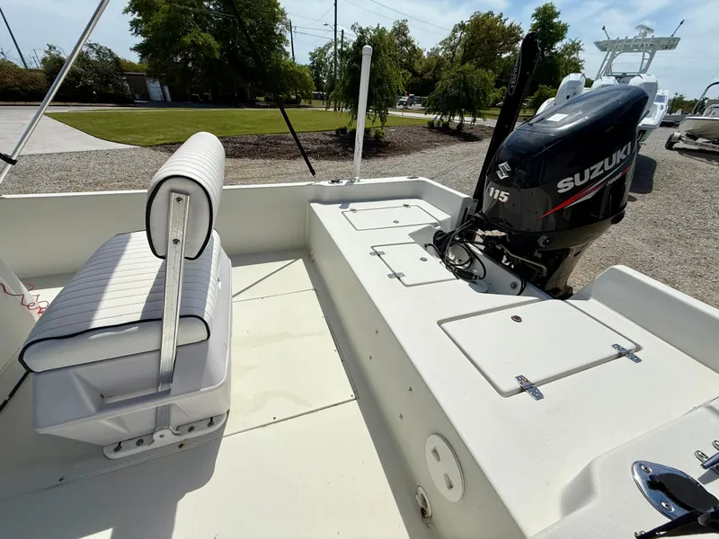 Slide: The Image of 2015 Stott Craft SCV 2160 Bay boat with Suzuki 115 engine, white seating, and storage compartments. - 22