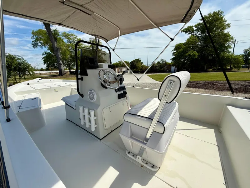 Slide: The Image of 2015 Stott Craft SCV 2160 Bay boat interior with console and seating under canopy. - 23