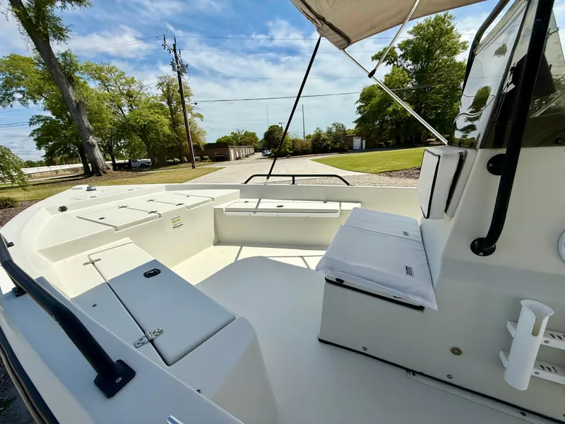 Slide: The Image of 2015 Stott Craft SCV 2160 Bay boat interior with seating and console, under clear sky. - 29