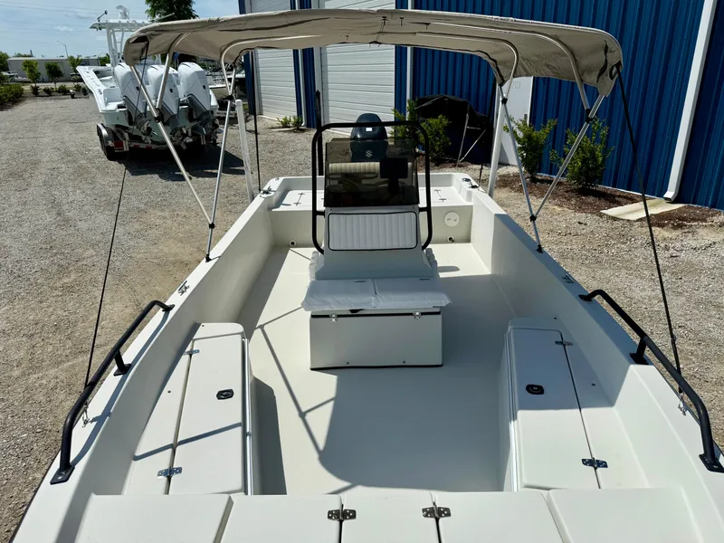 Slide: The Image of 2015 Stott Craft SCV 2160 Bay boat with canopy, parked on gravel near blue building. - 31