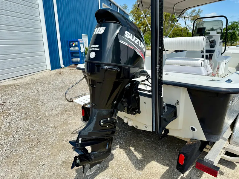 Slide: The Image of 2015 Stott Craft SCV 2160 Bay boat with Suzuki 115 outboard motor, parked outdoors. - 4