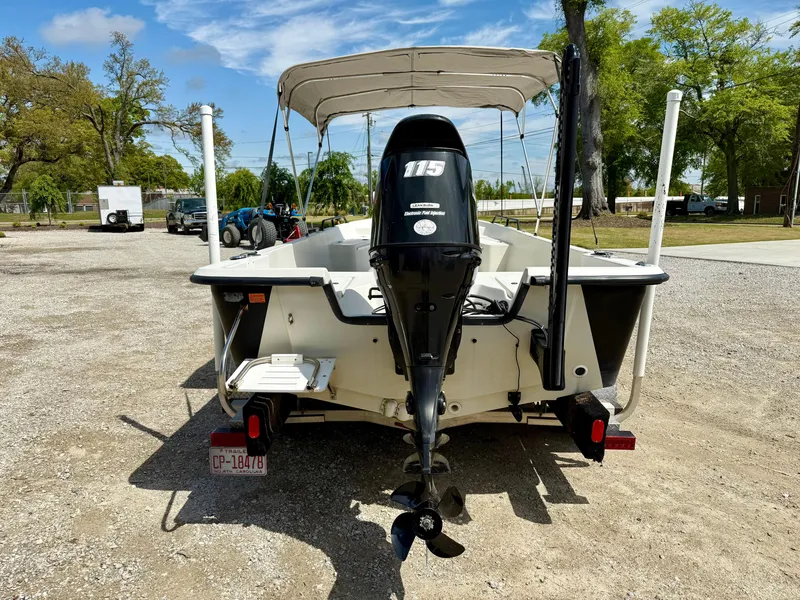 Slide: The Image of 2015 Stott Craft SCV 2160 Bay boat with outboard motor, parked on gravel. - 5