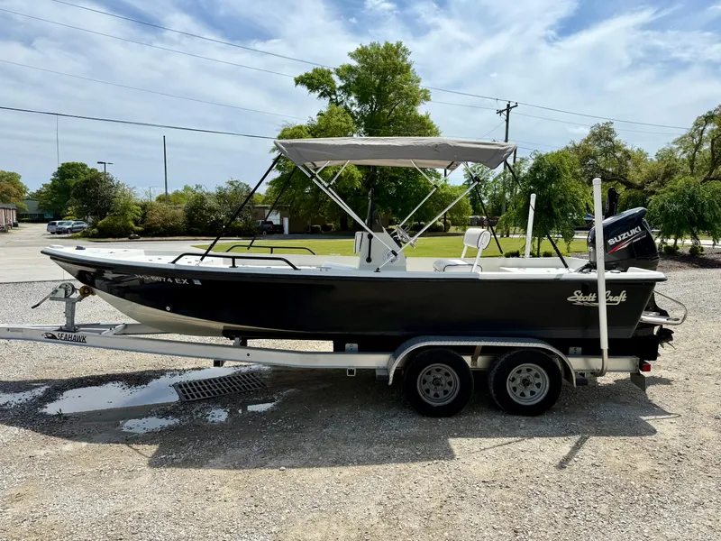 Slide: The Image of 2015 Stott Craft SCV 2160 Bay boat on trailer, parked outdoors. - 9