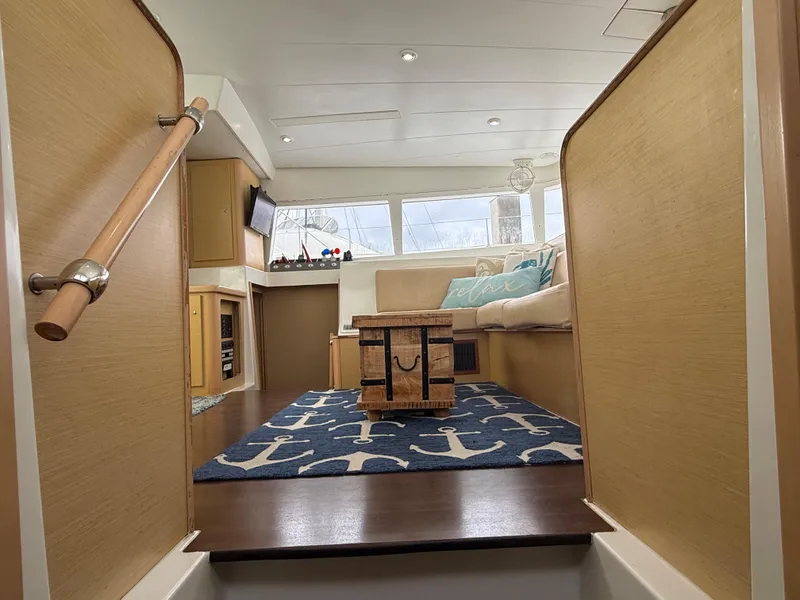 Slide: The Image of Interior of 2010 Lagoon 400 yacht, featuring cozy seating and nautical-themed decor. - 19
