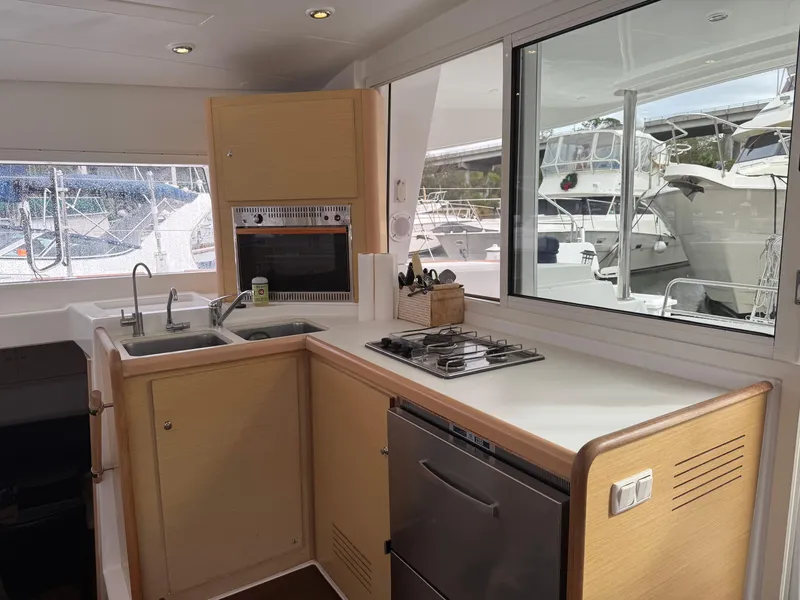 Slide: The Image of Modern kitchen in 2010 Lagoon 400 yacht with stove, sink, and marina view. - 20