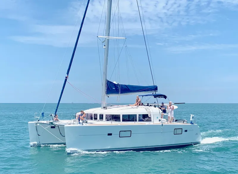Slide: The Image of 2010 Lagoon 400 Owner's Version catamaran sailing on open sea with new engines. - 21