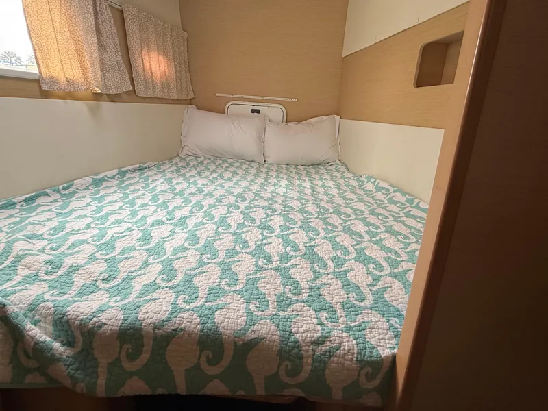 Slide: The Image of Cozy bedroom in 2010 Lagoon 400 yacht with seahorse-patterned bedding. - 25