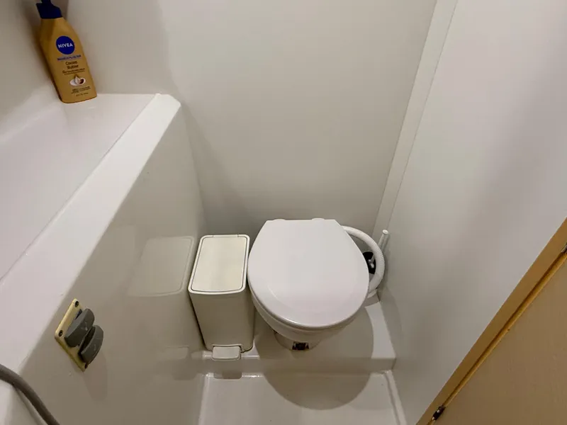 Slide: The Image of Compact bathroom in 2010 Lagoon 400 yacht, featuring a toilet and storage space. - 27