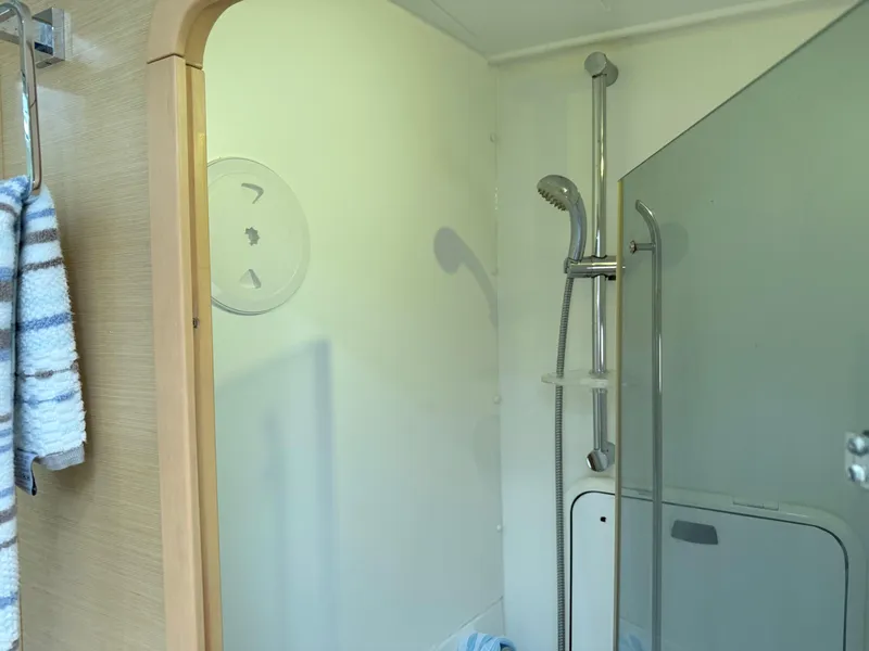 Slide: The Image of Shower area in 2010 Lagoon 400 Owner's Version yacht, featuring modern fixtures and glass partition. - 28