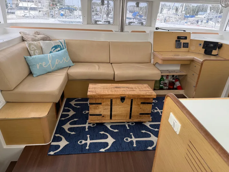 Slide: The Image of Interior of 2010 Lagoon 400 yacht with beige seating, nautical decor, and wooden accents. - 3