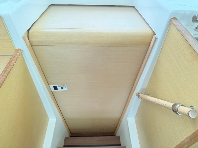 Slide: The Image of Interior stairs of 2010 Lagoon 400 Owner's Version yacht, featuring wooden finish and handrail. - 32