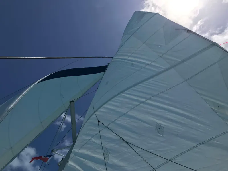 Slide: The Image of Sails of a 2010 Lagoon 400 catamaran against a clear blue sky. - 35