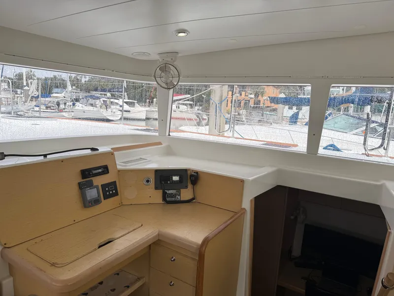 Slide: The Image of Interior view of 2010 Lagoon 400 sailboat, featuring navigation station and panoramic windows. - 5