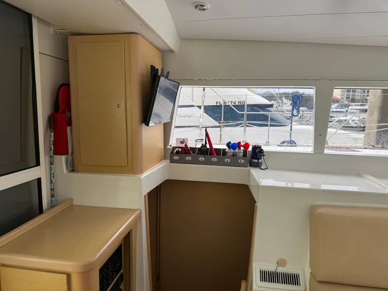Slide: The Image of Interior of 2010 Lagoon 400 yacht with modern amenities and marina view. - 6