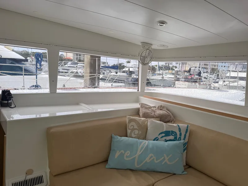 Slide: The Image of Interior of 2010 Lagoon 400 catamaran with cozy seating and "relax" pillow. - 8