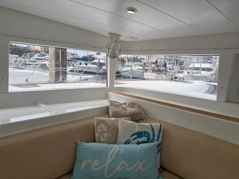 Slide: The Image of Interior of 2010 Lagoon 400 yacht with cozy seating and marina view. - 9