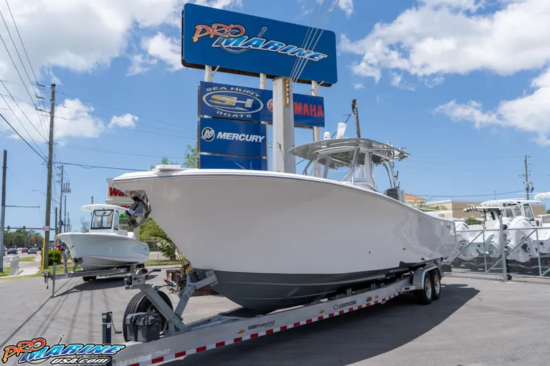 Slide: The Image of 2023 Front Runner 36 Center Console boat on trailer at dealership under clear sky. - 1