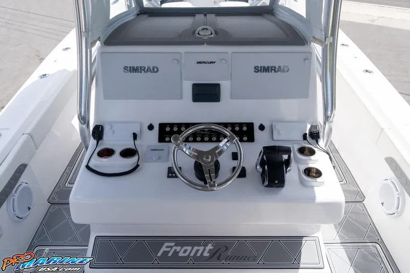 Slide: The Image of 2023 Front Runner 36 Center Console boat dashboard with steering wheel and controls. - 12