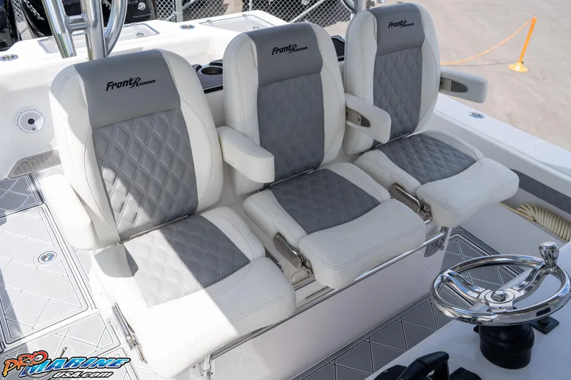 Slide: The Image of 2023 Front Runner 36 Center Console boat seats with diamond stitching and steering wheel. - 17