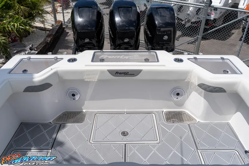 Slide: The Image of 2023 Front Runner 36 Center Console boat with triple outboard engines, spacious deck, and modern design. - 18