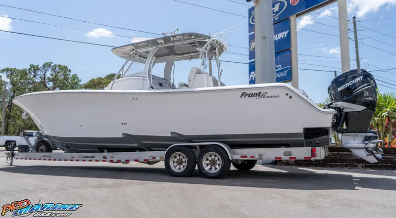 Slide: The Image of 2023 Front Runner 36 Center Console boat on a trailer, displayed outdoors. - 2