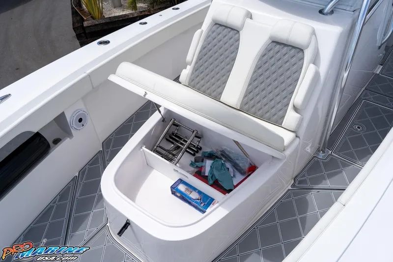 Slide: The Image of 2023 Front Runner 36 Center Console boat with open storage compartment and cushioned seating. - 9