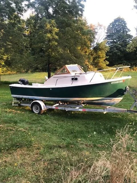 The Image of 1990 Custom North End Composites Point boat on trailer, parked on grassy area with trees. - 1