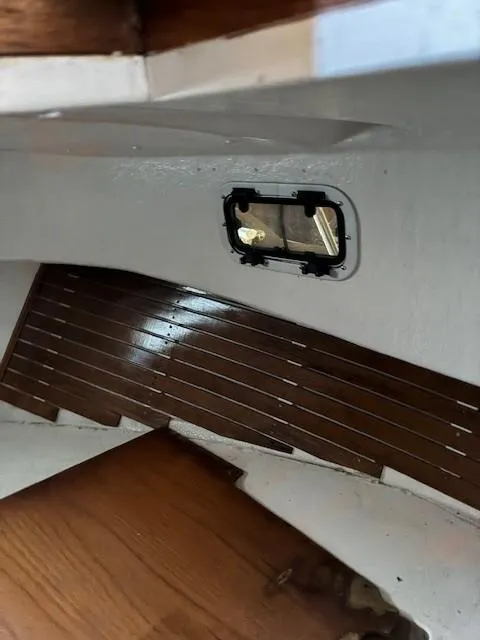 Slide: The Image of 1990 Custom North End Composites Point boat interior with wooden flooring and window detail. - 12