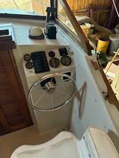 Slide: The Image of 1990 Custom North End Composites Point boat dashboard with steering wheel and gauges. - 15